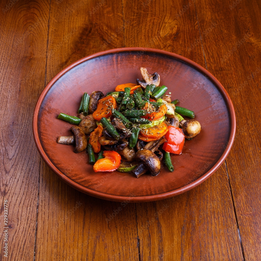 Stewed vegetables in the restaurant. On a wooden table Stewed vegetables in the restaurant. On a wooden table