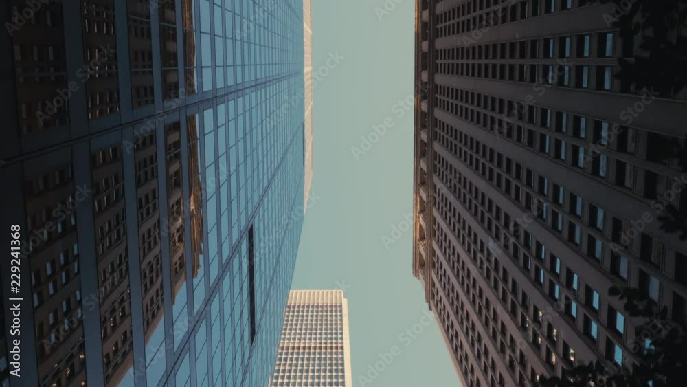 TRACKING GIMBAL Walking camera straight up through modern skyscraper buildings in downtown New York, USA. 4K UHD