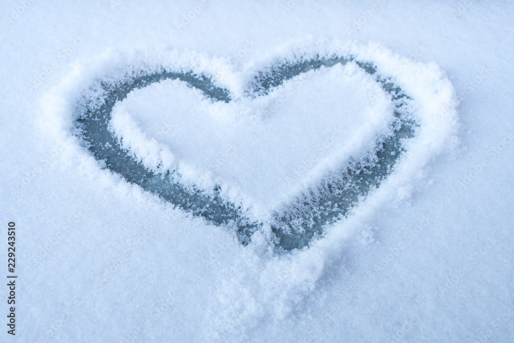 Heart shape drawn in a white snow. Heart shape drawn in a white snow.