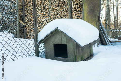 Empty doghouse in winter in the country side