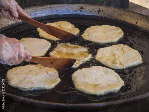 Romanian traditional Placinta are fried in a large frying pan. photo