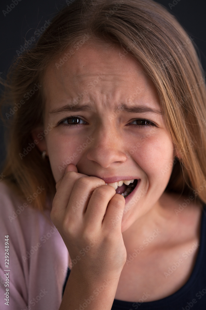 Exasperated young girl covering her mouth with her hand Exasperated young girl covering her mouth with her hand