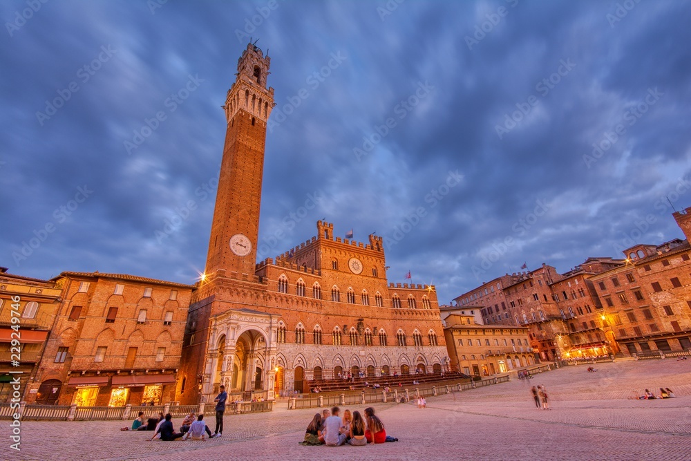 The Campo Square with Mangia Tower the landmark of Siena, Italy.