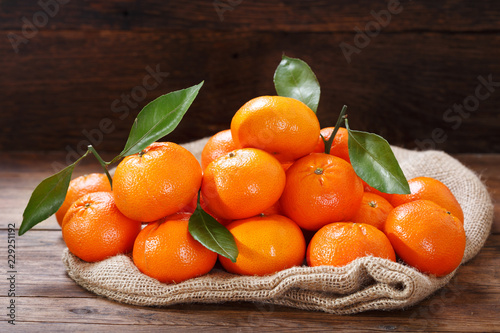 Fresh mandarin oranges fruit or tangerines on wooden table