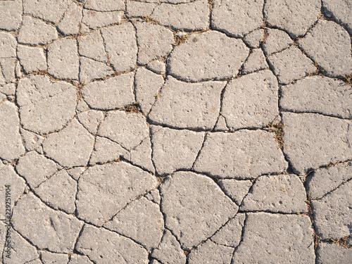 The texture of old asphalt with cracks. 