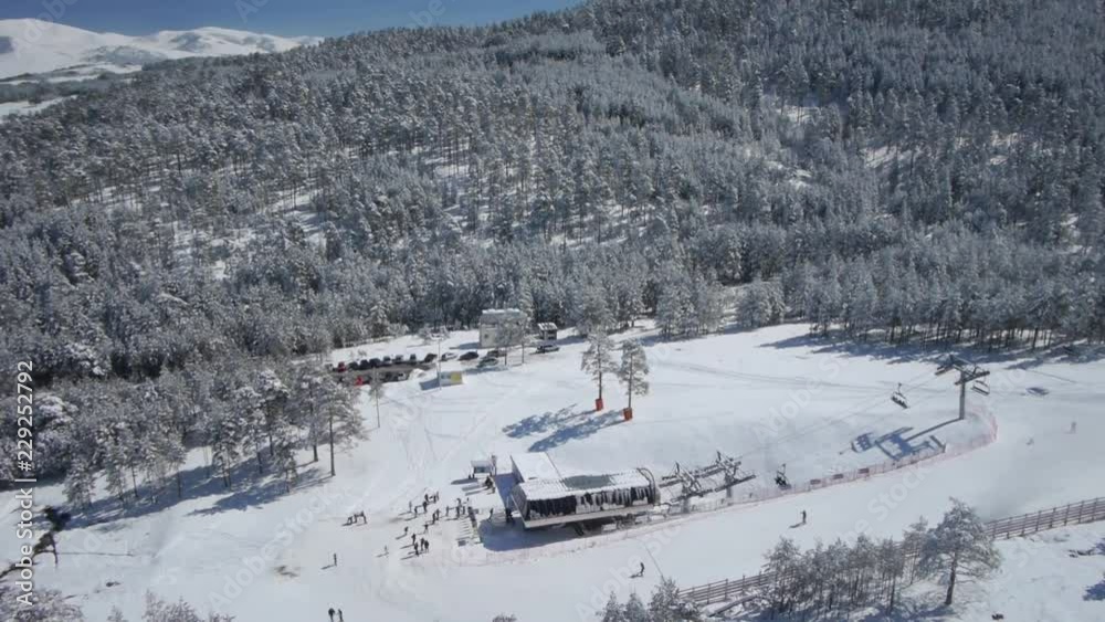 Aerial view of people skiing and ski lift at mountain ski resort. Aerial view of people skiing and ski lift at mountain ski resort.