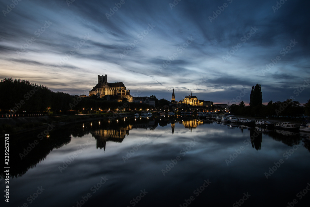 Auxerre, French city with cathedral and river at night