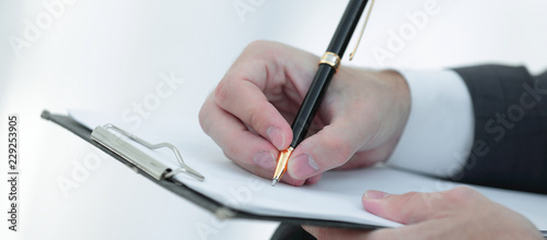 Businessman signs a contract. Holding pen in hand.