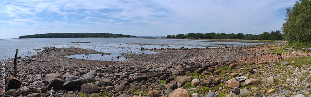 Wide view of Sears Island, the causeway and peninsula and coastline at Searsport Maine in the summertime.