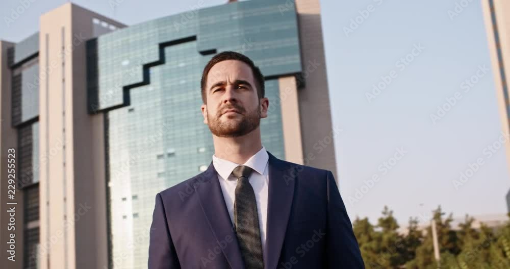 Confident mixed-ethnic businessman in suit and tie looking around, going down the city centre - closeup 4k Confident mixed-ethnic businessman in suit and tie looking around, going down the city centre - closeup 4k
