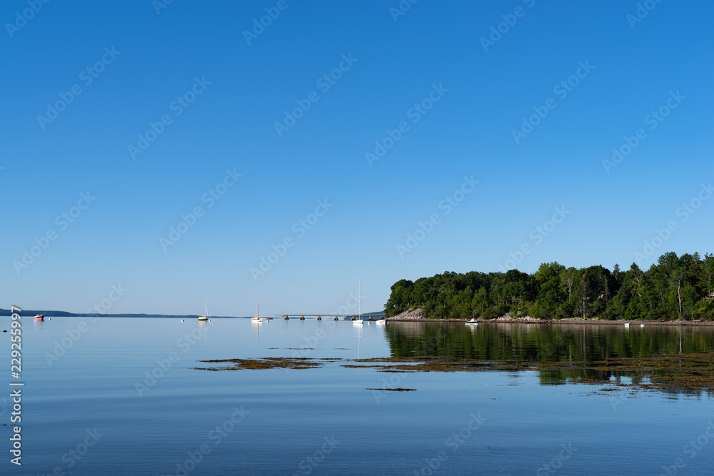View of Penobscot Bay from the shore at  Searsport, Maine in the early morning light with emphasis on the sky.