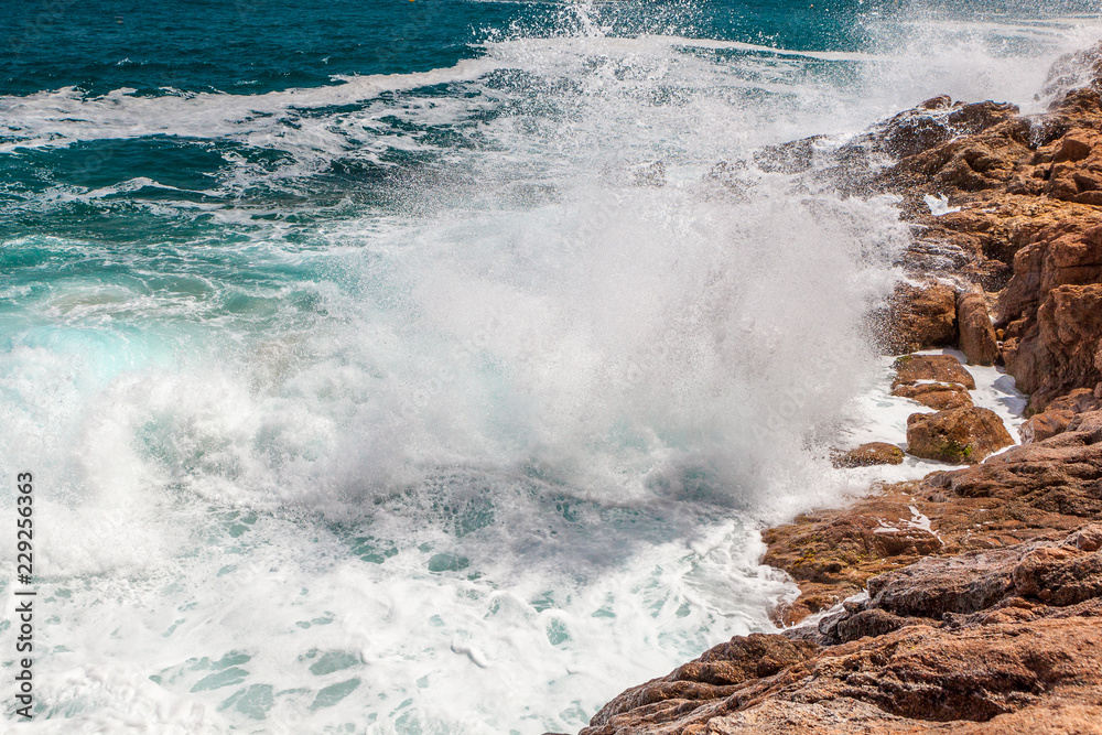 Rocks, waves and surf on the coastline shores and beach Rocks, waves and surf on the coastline shores and beach