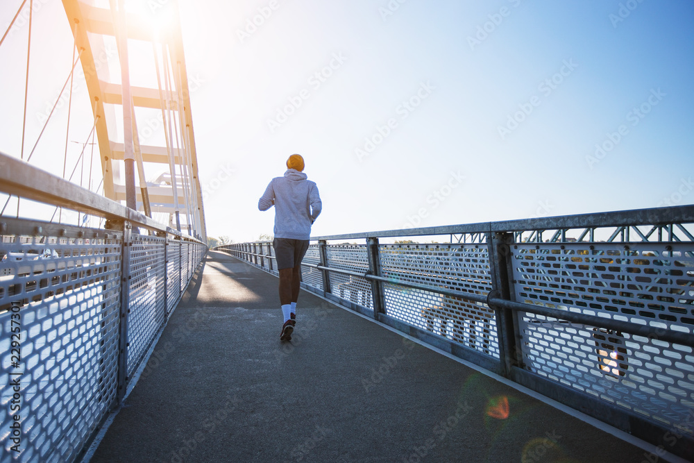 Man running on the bridge at morning