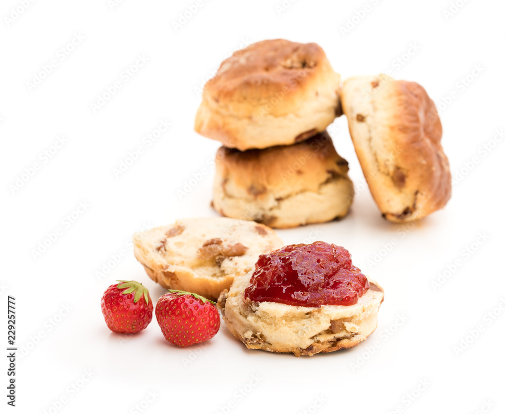 Traditional scones with fresh strawberries and jam isolated on white Traditional scones with fresh strawberries and jam isolated on white