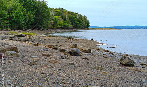A rocks and boulders on the shore of Sears Island at Searsport, Maine on an overcast summer day.