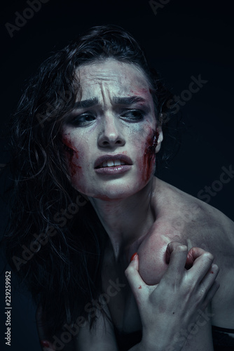 Beautiful girl with a scar on her face in the blood