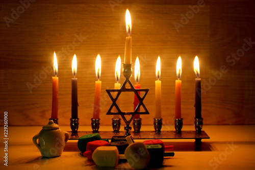 Hanukkah is a Jewish holiday. Burning Chanukah candlestick with candles. Chanukiah Menorah. dreidel, savivon photo