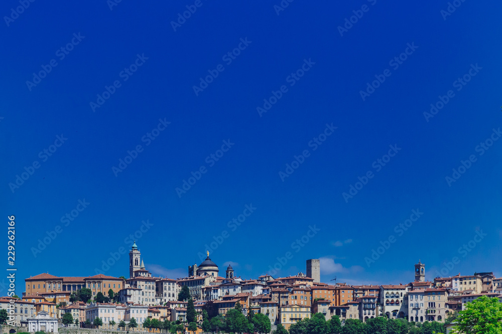 Skyline of Bergamo, Italy under blue sky