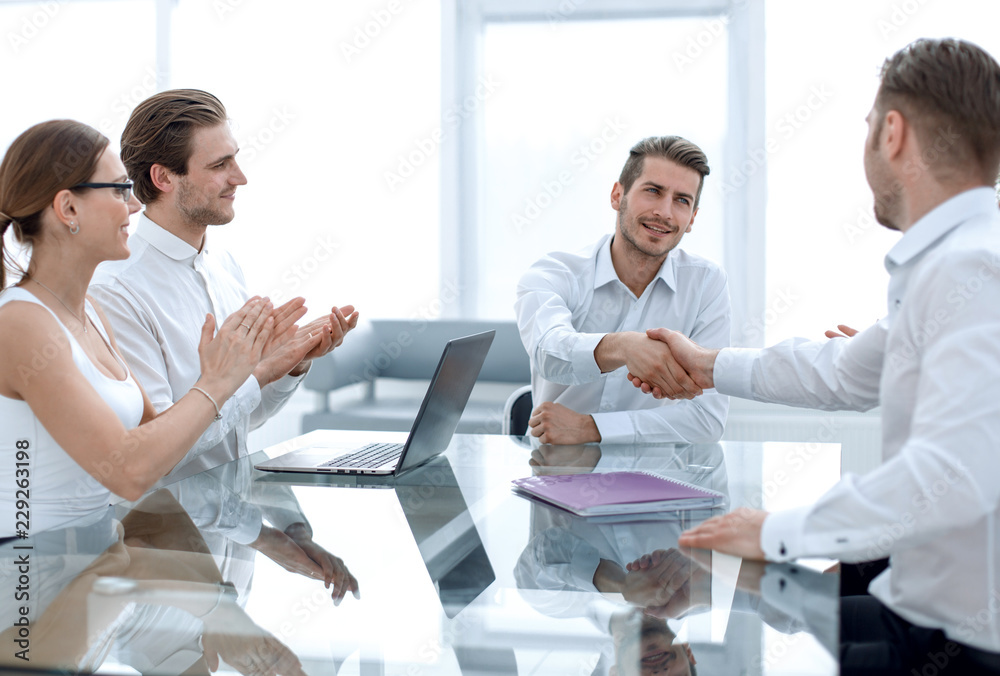 handshake business partners over the Desk handshake business partners over the Desk