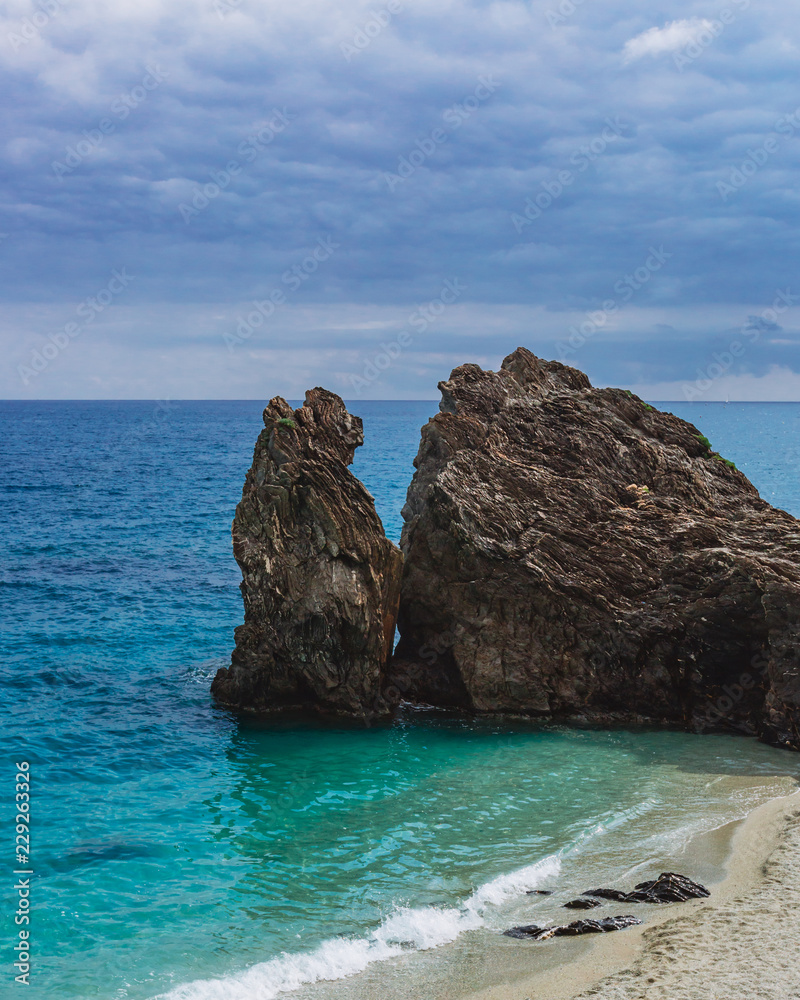 Big rocks by the blue sea in Monterosso, Cinque Terre, Italy