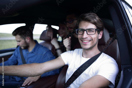 Close up side portrait of happy man driving car