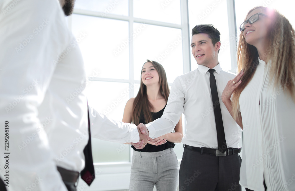 handshake between business colleagues in the office handshake between business colleagues in the office