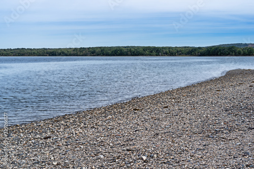 A rocky beach on the shore of Sears Island at Searsport, Maine on an overcast summer day.