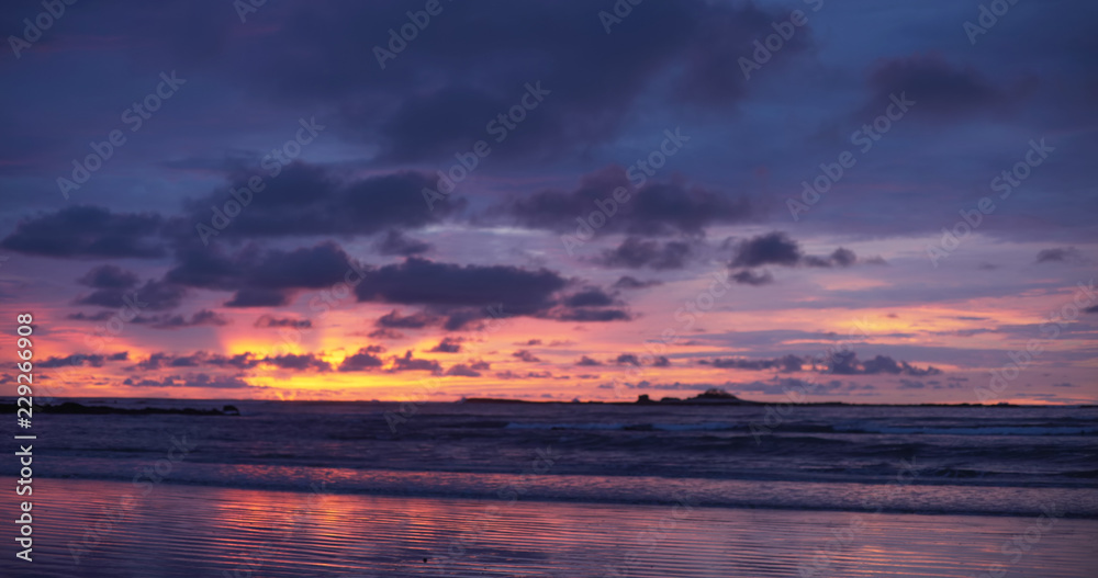 Background plate of beautiful orange, purple and blue sunset on the beach