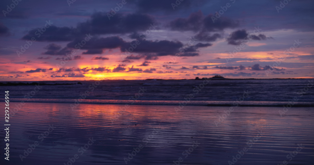 Fototapeta premium Background plate of gorgeous orange, purple and blue sunset over the ocean