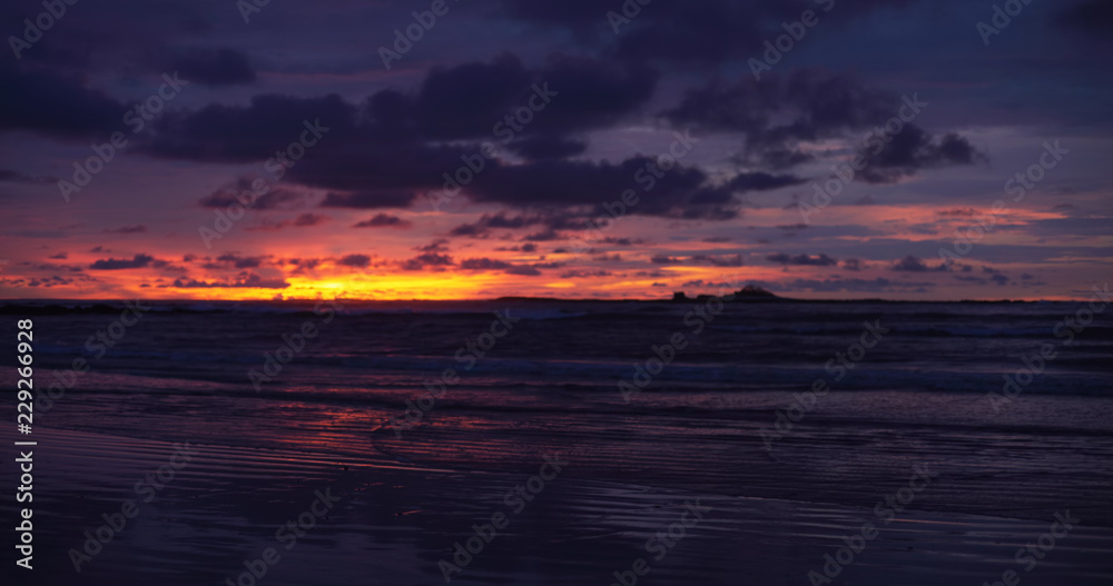 Gorgeous out of focus background plate of orange, purple and blue ocean sunset