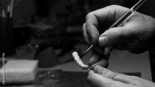 dental technician makes dental crowns. close-up. photo