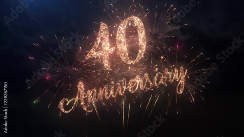 Happy birthday Anniversary 40 years celebration greeting text with particles and sparks on black night sky with colored slow motion fireworks on background, beautiful typography magic design.