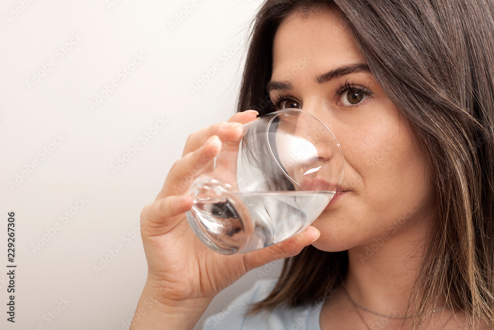 woman drinking a glass of water woman drinking a glass of water