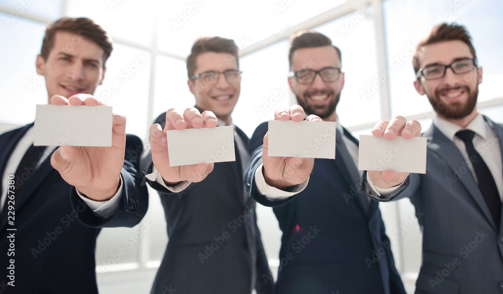 blank business cards in the hands of the business team blank business cards in the hands of the business team