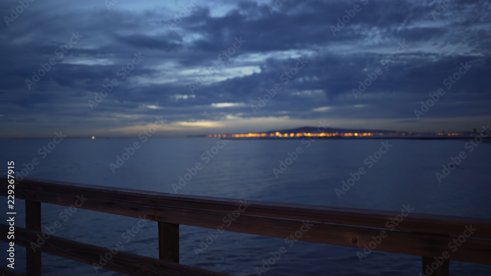 Fototapeta premium Background plate of Seal beach pier with a view of San Pedro just after sunset