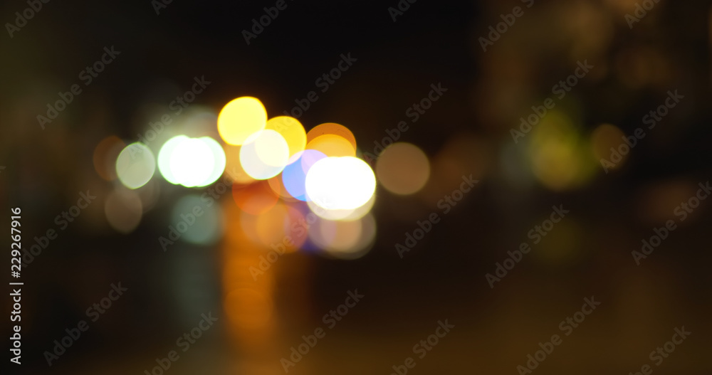 Fototapeta premium Background Plate of Bokeh out of focus lights on city street during rain storm