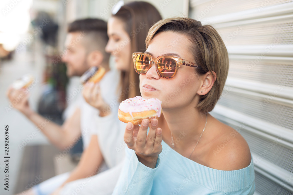 Beautiful woman eating a donut Beautiful woman eating a donut