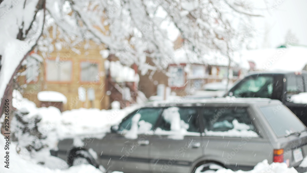 Fototapeta premium Snowy car parking lot near snow covered houses for background plate