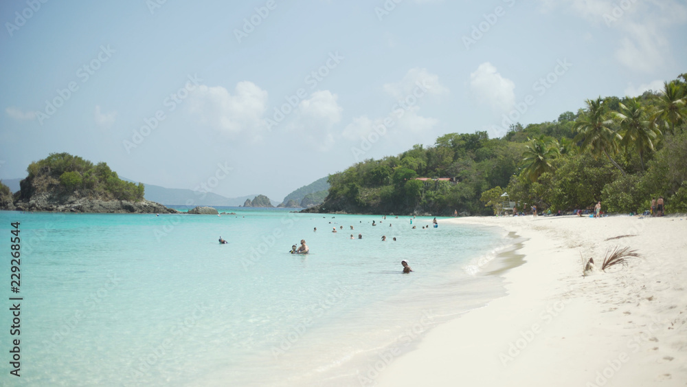 Fototapeta premium Tourists swimming in the distance in the Caribbean ocean for green screen