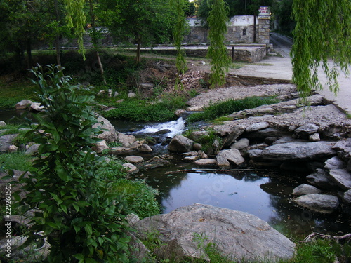 Little river among rocks and grass
