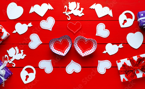 Person holding a present for Saint Valentine's day in his hands. Beautiful colorful background to st. Valentine day. Greeting card with red hearts. Wedding's invitation. Love expression. 