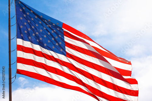 A Red White and Blue American Flag Waving in the Wind