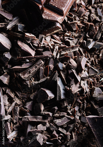 Chocolate. Shards of chopped chocolate on metal background.