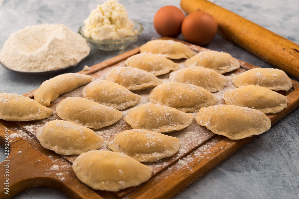 Preparation of dumplings from flour with eggs and cottage cheese filling.