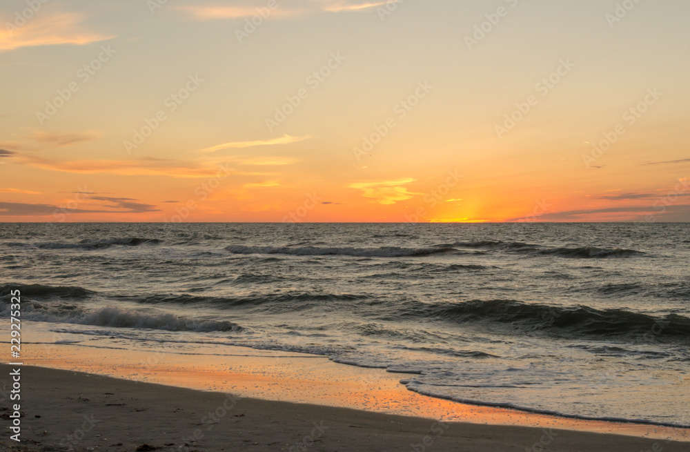Sunset or sunrise over the ocean with orange and yellow tones