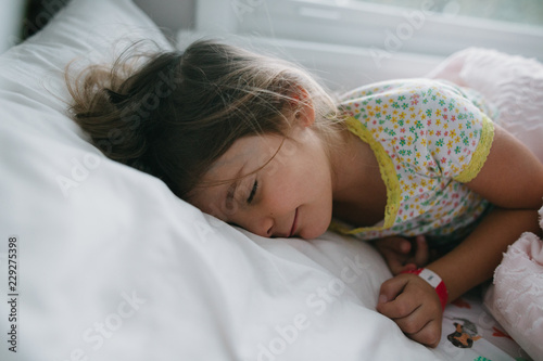 young girl sleeping in bed