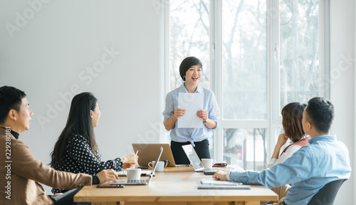 Businesswoman leading meeting in conference room photo