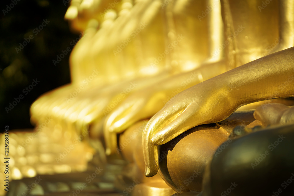 Close up golden hand buddha statue