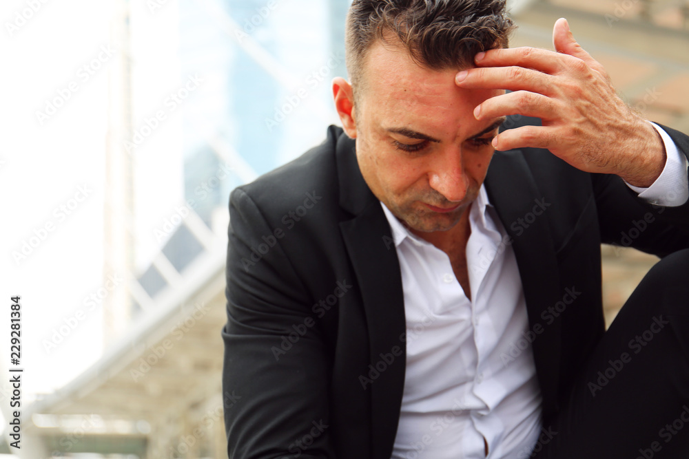Businessman sitting sadness and thinking work on walking street. Businessman sitting sadness and thinking work on walking street.