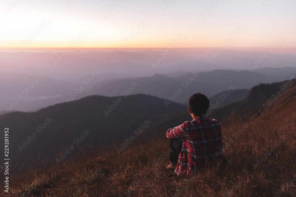He watched the mountain view and sunset on the mountain alone. He is happy to be with herself and stay with nature.